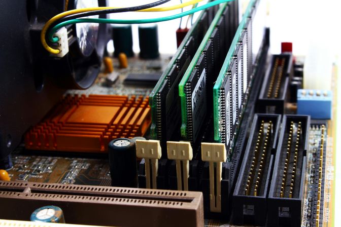 A motherboard with three RAM sticks.